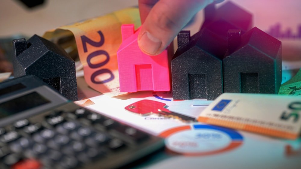 Modelo de vivienda junto a documentos de financiación hipotecaria
